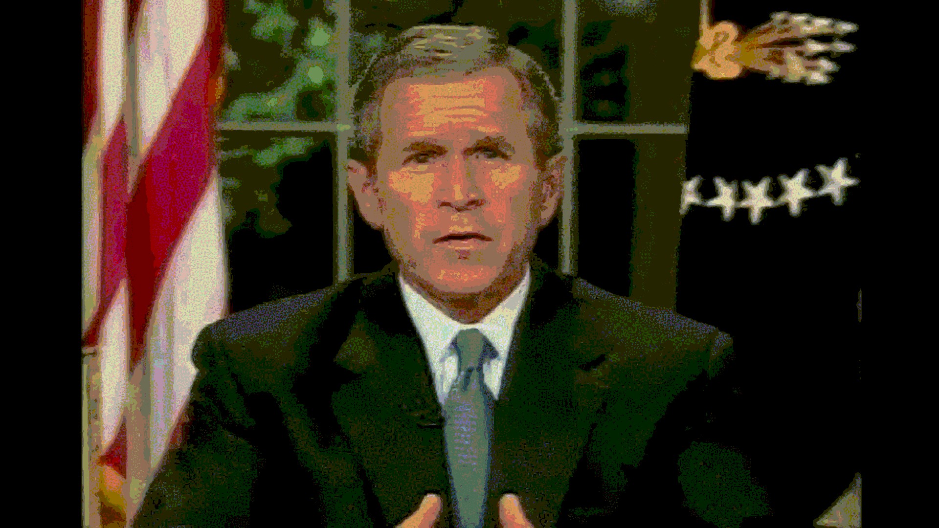 A psychedelic GIF of George W. Bush sitting at his then presidential desk in the oval office, being distorted in different ways.